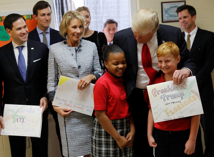 Betsy DeVos and President Donald Trump at Saint Andrew Catholic School in Orlando, Florida.