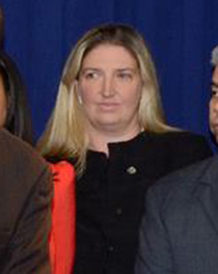 Tara Lenich is seen in the background of a Brooklyn District Attorney photo on Facebook.