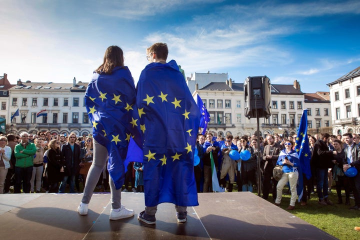 People hold European flags as they take part in the March For Europe on the 60th anniversary of the EU. March 25, Brussels. 