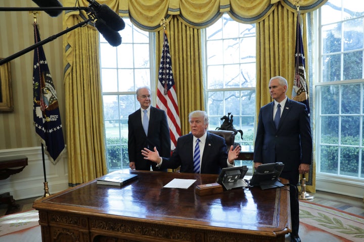President Trump talks to journalists at the Oval Office of the White House after the AHCA health care bill was pulled before a vote, accompanied by U.S. Health and Human Services Secretary Tom Price (L) and Vice President Mike Pence, in Washington, U.S., March 24, 2017.