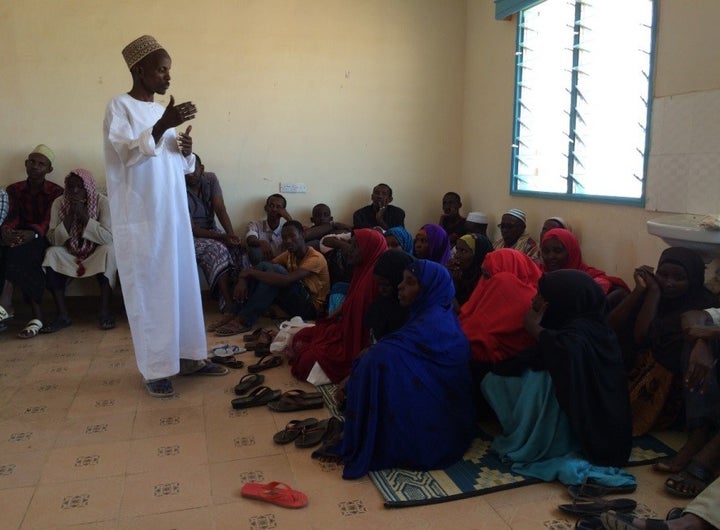 A religious leader in Kenya explains to a group of men and women in Kenya that family planning is important to their health and faith.