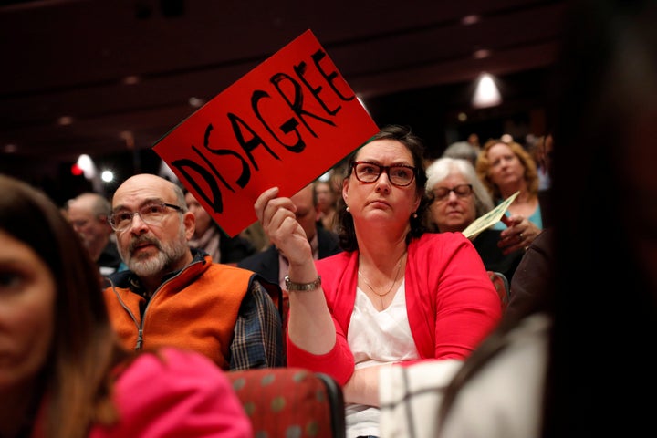 Elizabeth Lewandowski holds a sign as U.S. Congressman Leonard Lance (R-N.J.) hosts a town hall event at a community college in Branchburg, New Jersey.