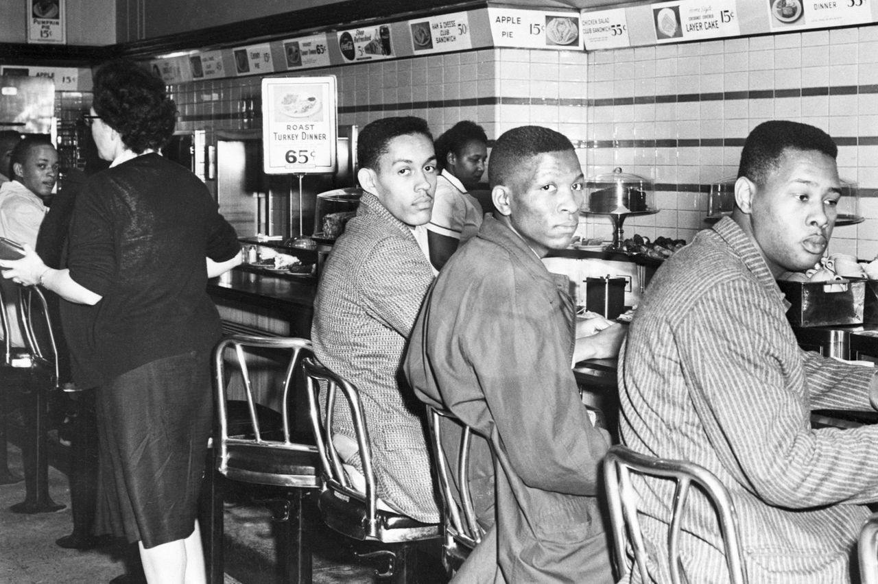 African-American students at North Carolina A&T College participate in a sit-in at a F. W. Woolworth's lunch counter reserved for white customers in Greensboro.