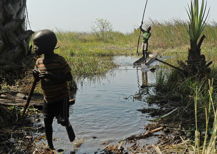 Children play in the water on Feb. 21, 2014, just off one of the islands in the Sudd swamplands in Unity state, central South Sudan, where they have fled with their families for safety.