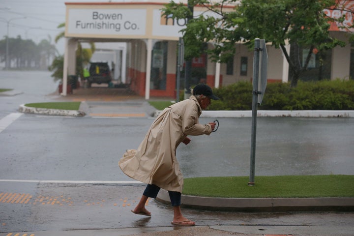 A brave local battles the wind before the worst of tropical cyclone Debbie hits in Bowen, Queensland.