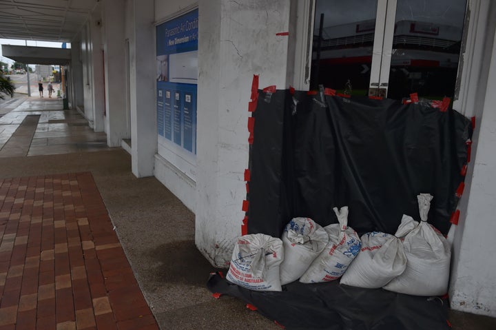 Sandbags are placed outside a business on an empty street in the town of Ayr in far north Queensland as Cyclone Debbie approa