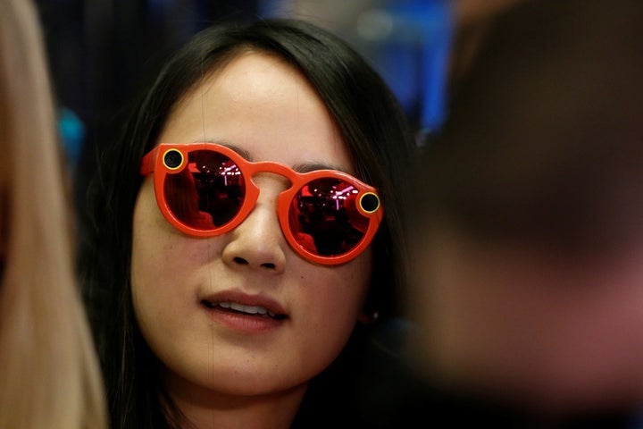 A woman wears Snapchat Spectacles on the floor of the New York Stock Exchange, on March 2, 2017.