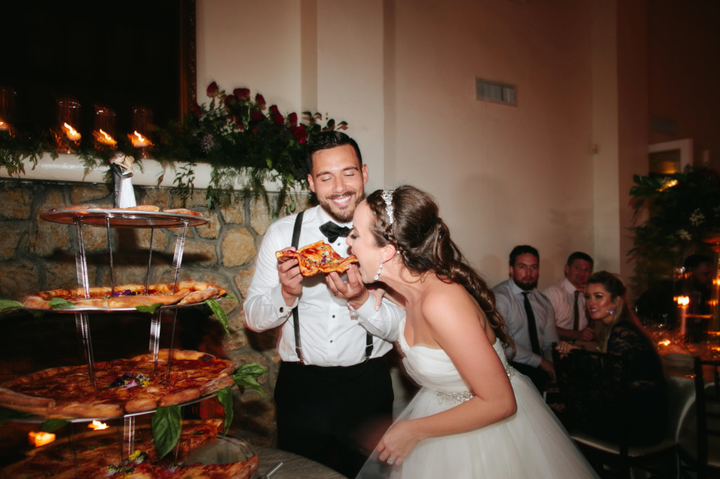 The beautiful bride went in for a big bite.&nbsp;