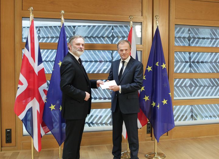Britain's EU ambassador Sir Tim Barrow hands the letter to Donald Tusk