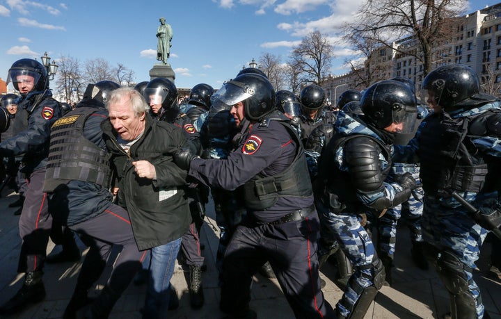 Law enforcement officers detain an opposition supporter during a rally in Moscow, Russia, March 26, 2017.