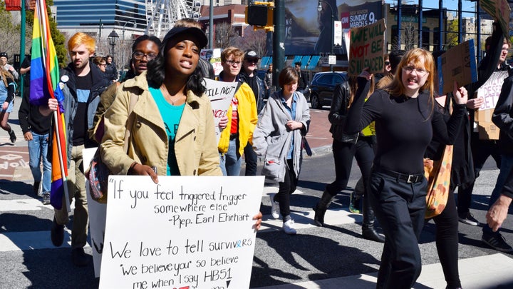 Venkayla Haynes, holding a sign quoting Rep. Earl Ehrhart saying “If you feel triggered, trigger somewhere else”, participates in the “March for Survivors” to protest House Bill 51 on March 3, 2017.