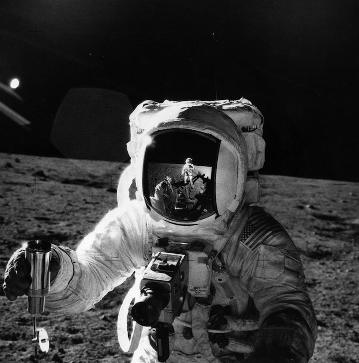 Astronaut Alan Bean holds a container of lunar soil collected during Apollo 12 extravehicular activity.