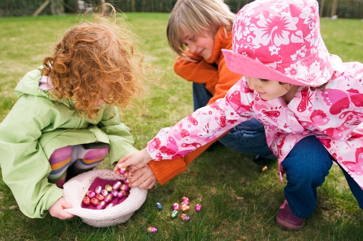 3 children in garden with Easter eggs Pascal Broze via Getty Images