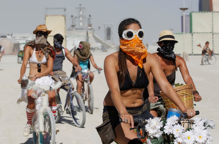 Participants wear face masks and goggles to protect themselves during a dust storm in the midst of the Burning Man.