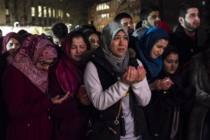 Friends and family pray at a vigil for three Muslims who were shot dead in Chapel Hill, North Carolina.