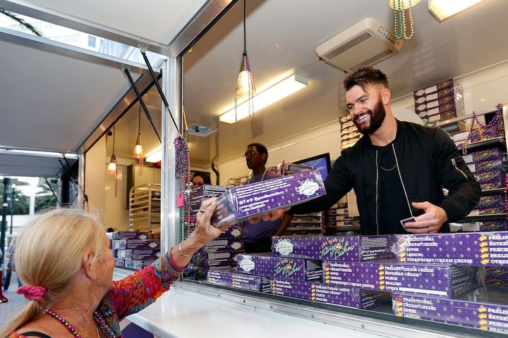 Country music artist Dylan Scott helps Crown Royal inspire generosity by passing out king cakes in exchange for Mardi Gras beads at the Crown Royal pop-up event on February 24, 2017 in New Orleans, Louisiana.