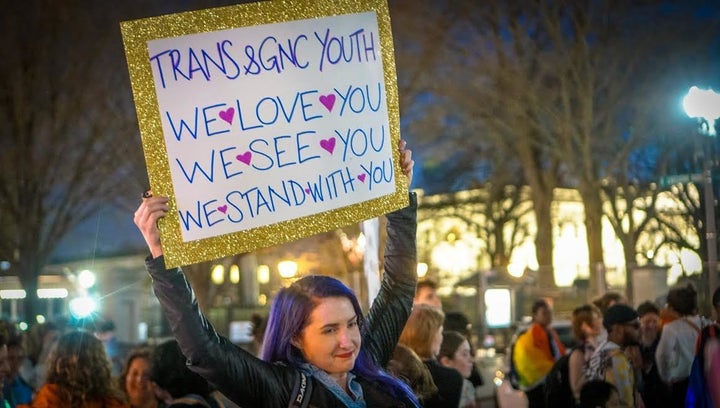 A protestor holds a sign at the last dance protest.