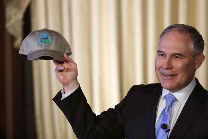 Environmental Protection Agency Administrator Scott Pruitt holds up an an agency baseball hat as he addresses employees at the agency's headquarters in February.