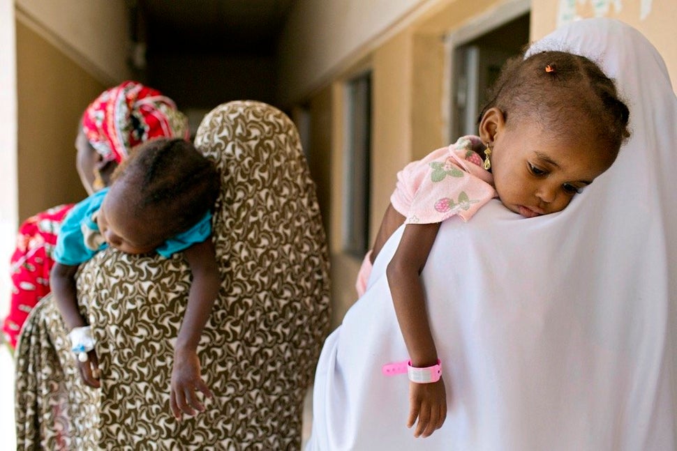 Mothers take their children, suffering from severe acute malnutrition, to receive further examinations that will help doctors