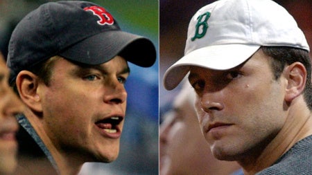 Matt Damon and Ben Affleck wearing Boston Red Sox hats.