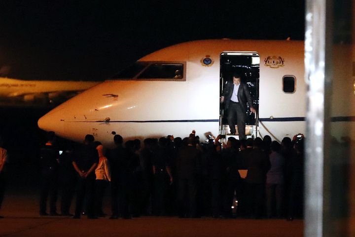 One of the Malaysians stranded in Pyongyang walks down from a plane after arriving at Kuala Lumpur on Friday