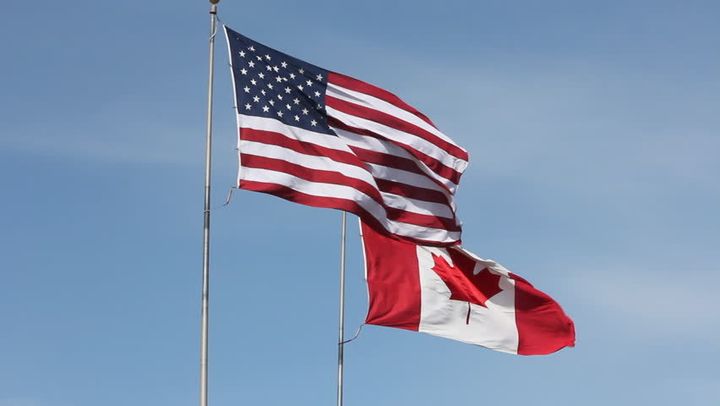 Flags of the United States and Canada.