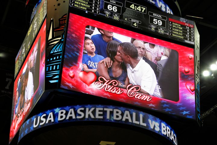 President Barack Obama and first lady Michelle Obama are shown kissing on the "Kiss Cam" screen during a time out in the Olympic basketball exhibition game between the U.S. and Brazil national men's teams in Washington, July 16, 2012.