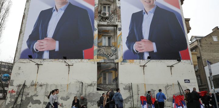 People pass posters of Serbian prime minister Aleksandar Vucic, in Novi Sad, Serbia March 18, 2017. 