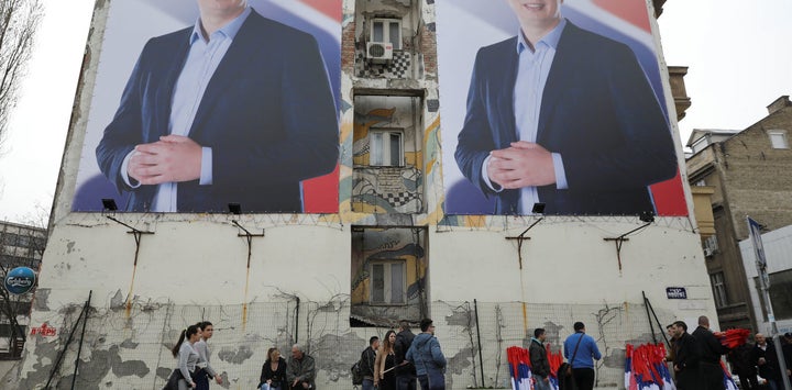 People pass posters of Serbian prime minister Aleksandar Vucic, in Novi Sad, Serbia March 18, 2017.