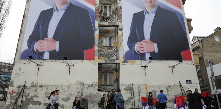 People pass posters of Serbian prime minister Aleksandar Vucic, in Novi Sad, Serbia March 18, 2017. 