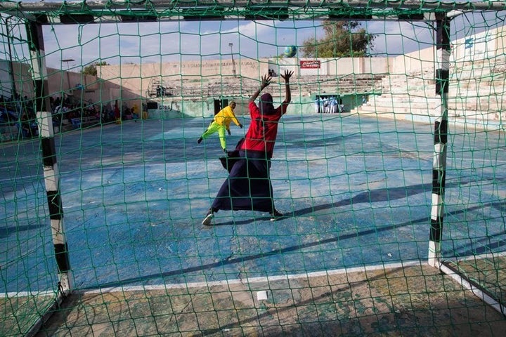 Two young women warm up before the finals of the Somali Women’s Handball Tournament in Mogadishu, in November 2016.