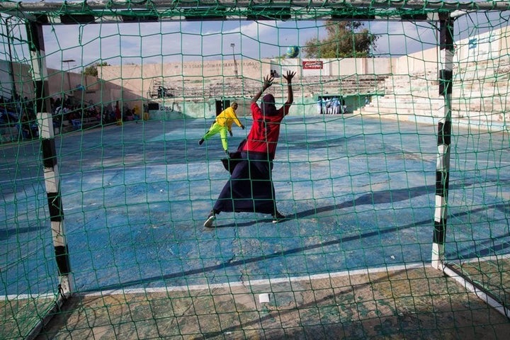 Two young women warm up before the finals of the Somali Women’s Handball Tournament in Mogadishu, in November 2016.