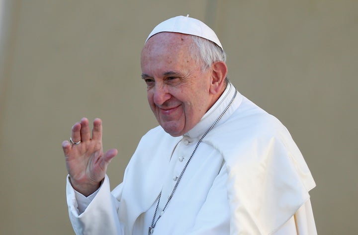 Pope Francis waves as he arrives to lead his Wednesday general audience in Saint Peter's square at the Vatican, March 29, 201