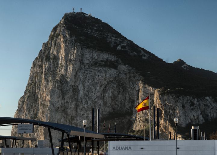 A Spanish flag flies on top of the customs house on the Spanish side of the border between Spain and Gibraltar