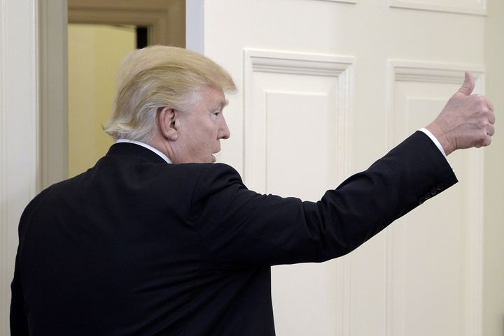President Donald Trump gives a thumbs up after speaking about trade in the Oval Office on March 31.
