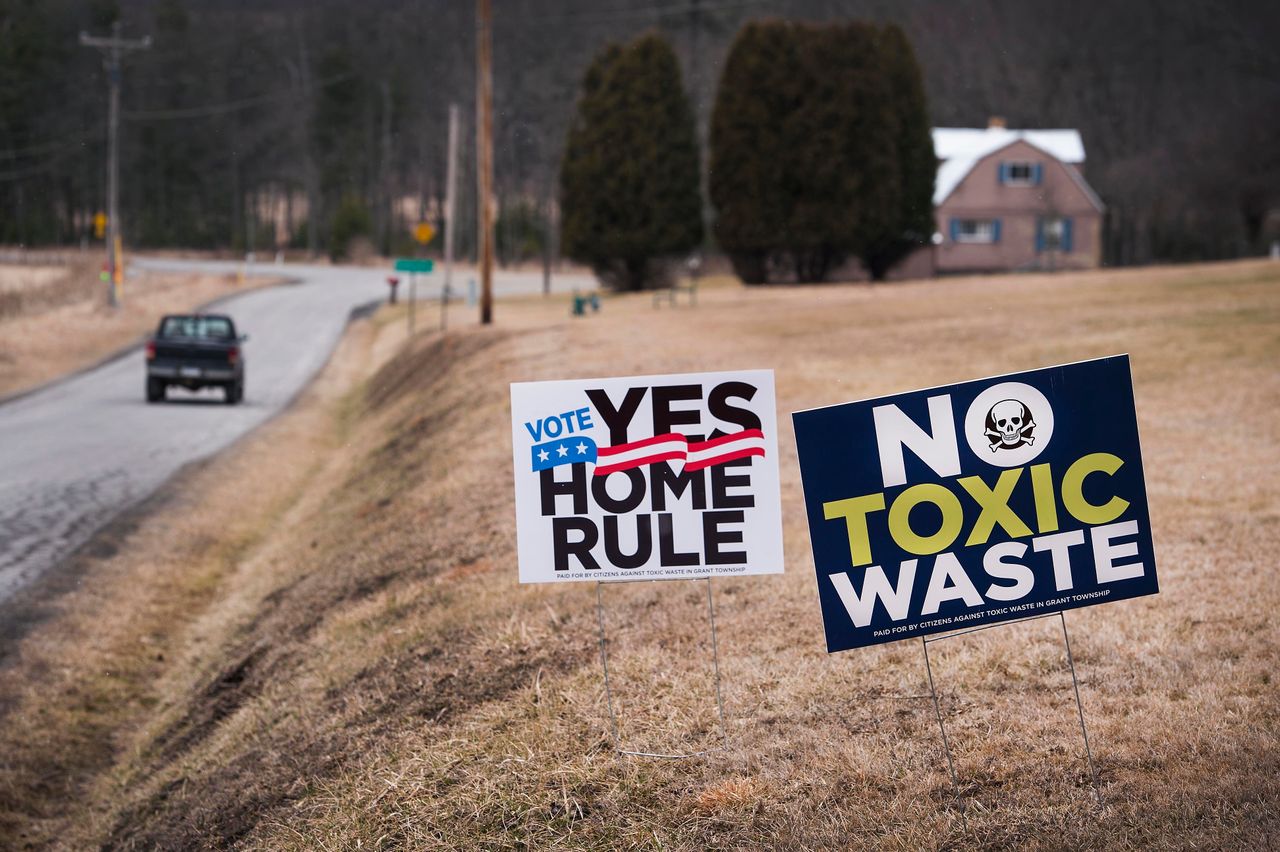Signs in Grant Township, Pennsylvania, oppose a fracking wastewater injection well and advocate for "home rule," which gives the township broad power to legislate.