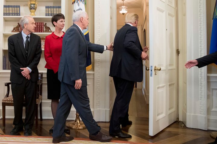Vice president Mike Pence reaches for Donald Trump as he walks out of the ceremony