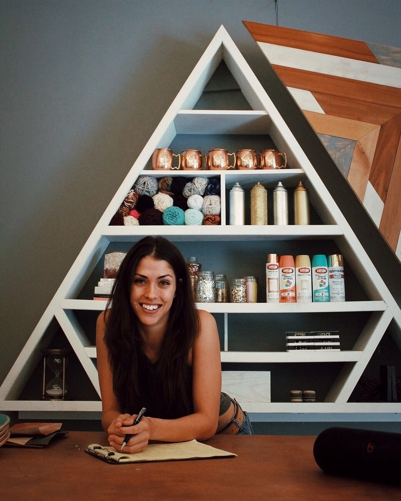 Rachel Metz pictured with her hand-crafted copper workshop table and triangular shelf, centre pieces for many of her videos.