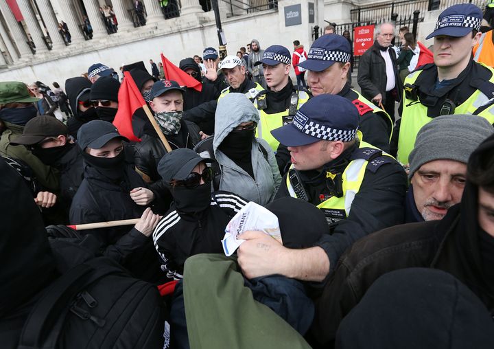 UAF (Unite Against Fascism) demonstrators tussle with police officers in Trafalgar Square