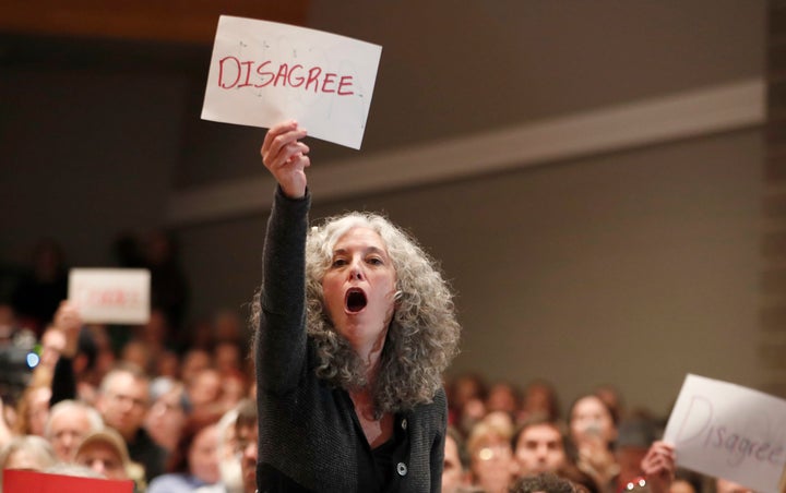 An attendee yells a question at Rep. Chris Stewart at a town hall meeting.