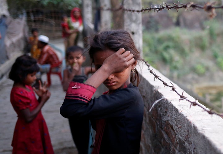 A Rohingya refugee girl wipes her eyes as she cries at Leda Unregistered Refugee Camp in Teknaf, Bangladesh, February 15, 201