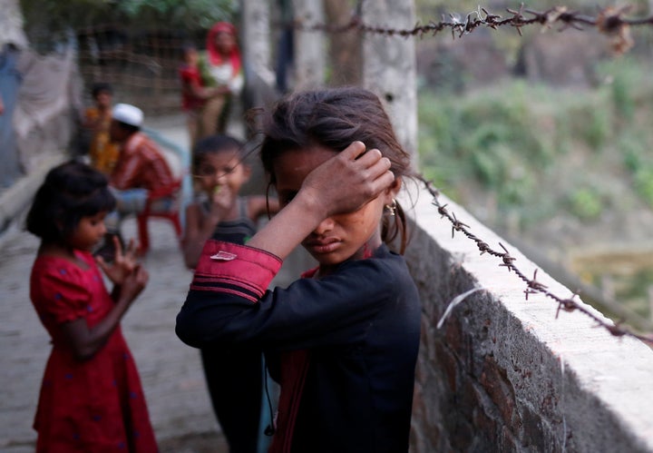 A Rohingya refugee girl wipes her eyes as she cries at Leda Unregistered Refugee Camp in Teknaf, Bangladesh, February 15, 2017.