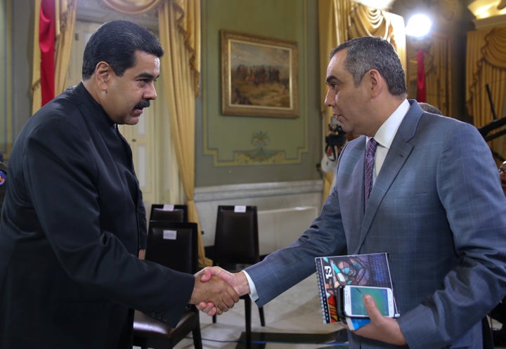 President Nicolas Maduro (L) and Supreme Court President Maikel Moreno shake hands during a meeting at Miraflores Palace in C