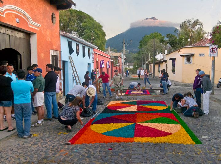 Near our apartment the neighborhood alfombras being prepared with cloud-circled, Volcán de Fuego looming. 