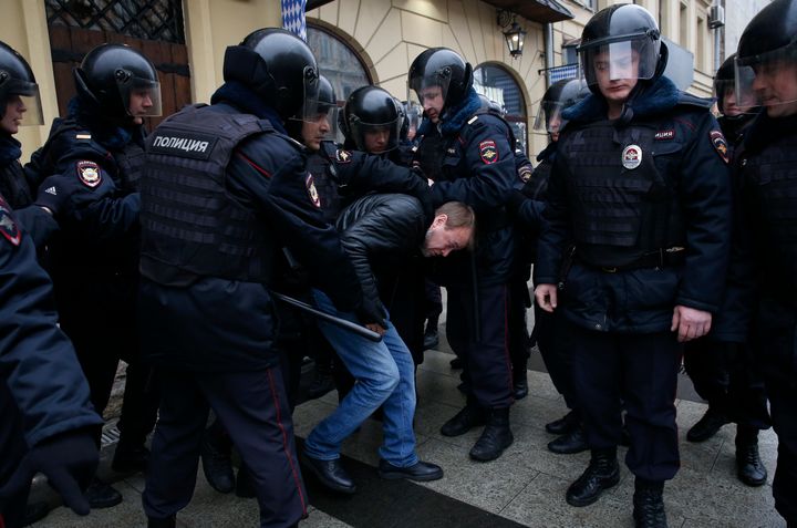 Policemen detain a man during an unsanctioned anti-government protest in Moscow, Russia, April 2, 2017.
