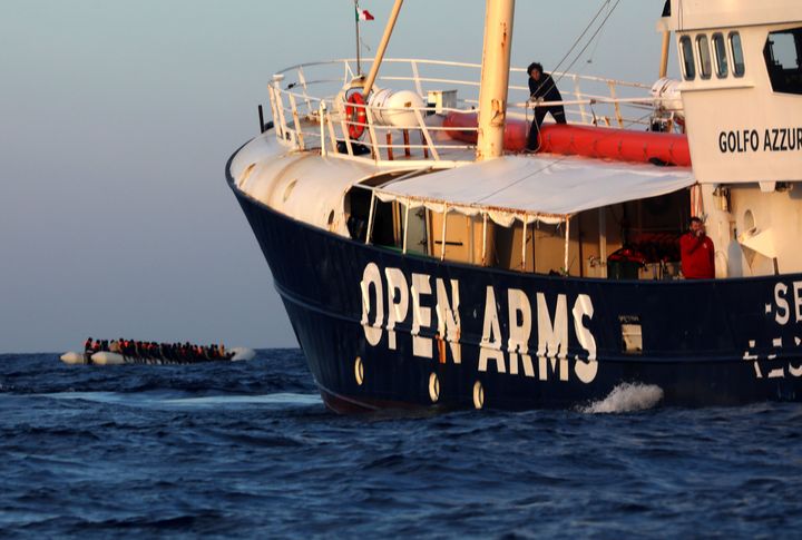 An overcrowded plastic raft with migrants is seen drifting ahead of the former fishing trawler Golfo Azzurro, during a search and rescue operation by Spanish NGO Proactiva Open Arms in central Mediterranean Sea. 