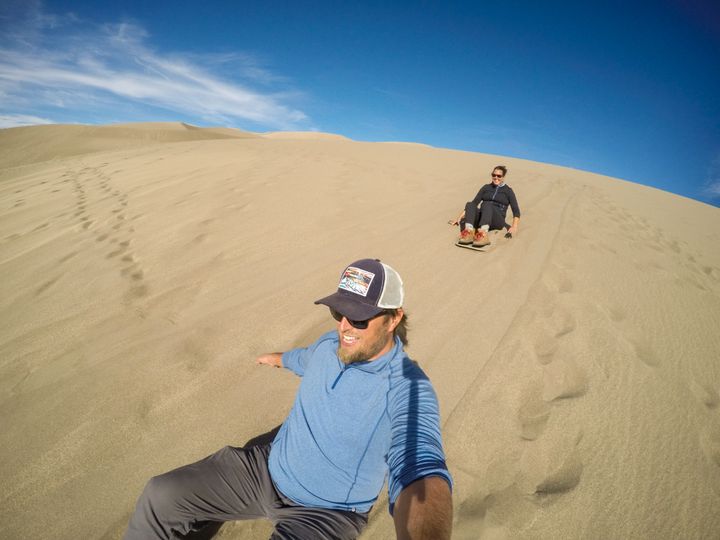Sand boarding in Great Sand Dunes National Park in Colorado. 