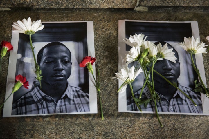 Flowers rest atop of pictures of Kalief Browder in New York, June 11, 2015. 