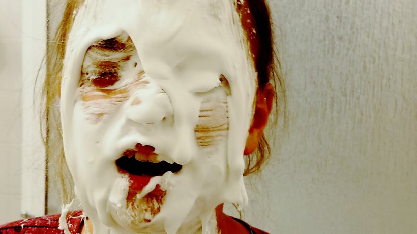 Olive covered in a mixture of eye contact solution, glue, baking soda, water, and shaving foam.