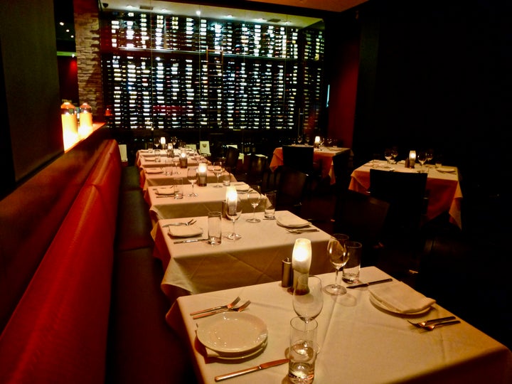 The elegant dining room and wall of wines.